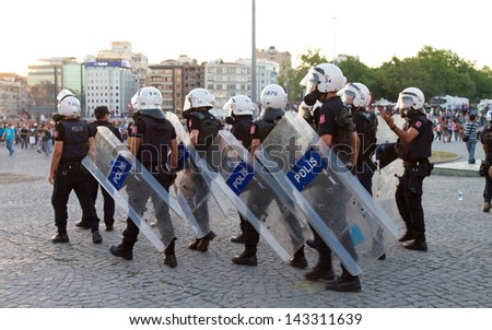 ISTANBUL - JUNE 22: Police intervention to protestors in Taksim Square on June 22, 2013 in Istanbul, Turkey. People came Taksim Square with red carnations to commemoration for dead during protests