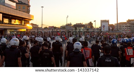 ISTANBUL - JUNE 22: Police intervention to protestors in Taksim Square on June 22, 2013 in Istanbul, Turkey. People came Taksim Square with red carnations to commemoration for dead during protests