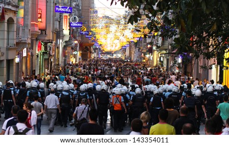 ISTANBUL - JUNE 22: Police intervention to protestors in Ã?Â?Ã?Â�stiklal Street on June 22, 2013 in Istanbul, Turkey. People came Taksim Square with red carnations to commemoration for dead during protests