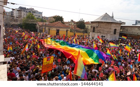 ISTANBUL - JUNE 30: People in Taksim Square for LGBT pride parade on June 30, 2013 in Istanbul, Turkey. Almost 100.000 people attracted to pride parade and the biggest pride ever held in Turkey.