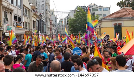 ISTANBUL - JUNE 30: People in Taksim Square for LGBT pride parade on June 30, 2013 in Istanbul, Turkey. Almost 100.000 people attracted to pride parade and the biggest pride ever held in Turkey.