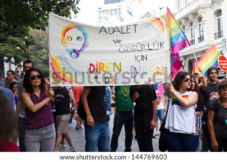 ISTANBUL - JUNE 30: People in Istiklal Street for LGBT pride parade on June 30, 2013 in Istanbul, Turkey. Almost 100.000 people attracted to pride parade and the biggest pride ever held in Turkey.