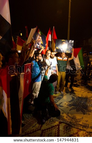 ISTANBUL - JULY 27: People gathered and press release in Taksim Square to support Egypt\'s Ex-President Mohamed Morsi in Turkey on July 27, 2013 in Istanbul, Turkey.