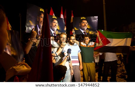 ISTANBUL - JULY 27: People gathered and press release in Taksim Square to support Egypt\'s Ex-President Mohamed Morsi in Turkey on July 27, 2013 in Istanbul, Turkey.