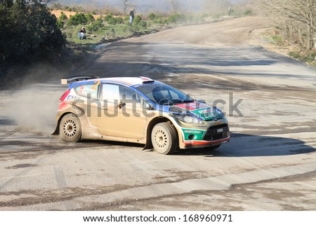 ISTANBUL - DECEMBER 15: Murat Bostanci drives Ford Fiesta S2000 of Castrol Ford Team Turkey in 34th Opar Olio Istanbul Rally, Ulupelit Stage on December 15, 2013 in Istanbul, Turkey.