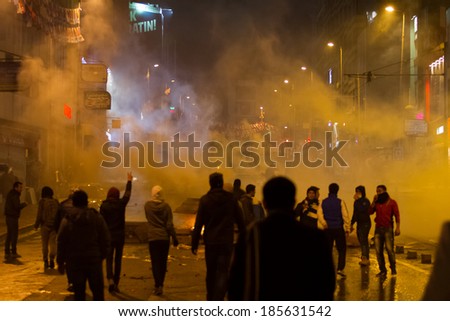 ISTANBUL, TURKEY - MARCH 11, 2014: Police intervene with tear gas in Kadikoy during protest after Berkin Elvan, who was 15 years old, died. He was hit in the head with a tear gas canister by Police