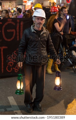 ISTANBUL, TURKEY - MAY 18, 2014: A man with torch in Kadikoy to protest against the ruling AKP over the Soma mine disaster.