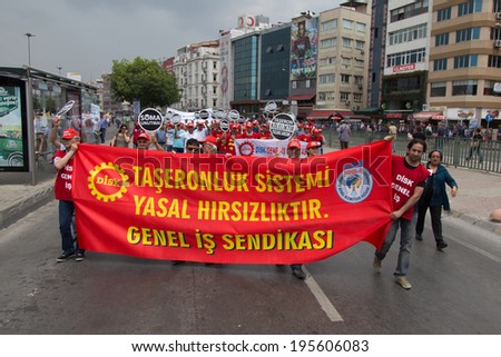 ISTANBUL, TURKEY - MAY 25, 2014: Unions march in protest against subcontractors in Turkey. Subcontracting system is legalized theft write on banner