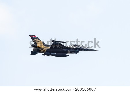 IZMIT, TURKEY - JUNE 28, 2014: Solo Turk demonstration team put on a show to public in Izmit city celebrating 93 years of liberation from enemy occupation. Airplane is a F-16 C Blok-40 fighter jet.