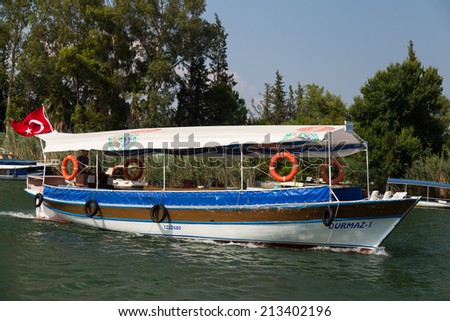 DALYAN, MUGLA, TURKEY - JULY 18, 2014: Tour boat in Dalyan river. River tour between Koycegiz lake and Iztuzu beach is one of the most populer activity in Dalyan.