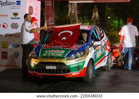 ISTANBUL, TURKEY - AUGUST 15, 2014: Ferhat Tanribilir with Ford Fiesta R2 car of Castrol Ford Team Turkiye in ceremonial start of Avis Bosphorus Rally