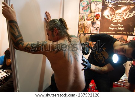 ISTANBUL, TURKEY - SEPTEMBER 20, 2014: Tattoo artist works in Istanbul Tattoo Convention which held in Kadikoy.
