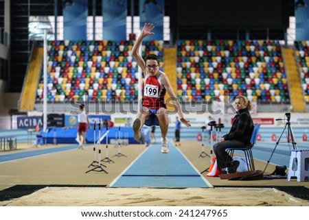 ISTANBUL, TURKEY - DECEMBER 27, 2014: Athlete Sinan Bircan triple jump during Athletics record attempt races in Asli Cakir Alptekin Athletics hall, Istanbul.