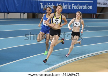 ISTANBUL, TURKEY - DECEMBER 28, 2014: Athletes run during Athletics record attempt races in Asli Cakir Alptekin Athletics hall, Istanbul.