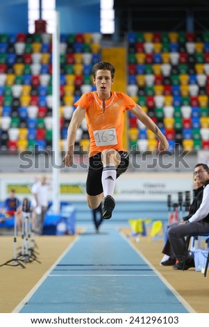 ISTANBUL, TURKEY - DECEMBER 28, 2014: Athlete Mert Cicek triple jump during Athletics record attempt races in Asli Cakir Alptekin Athletics hall, Istanbul.