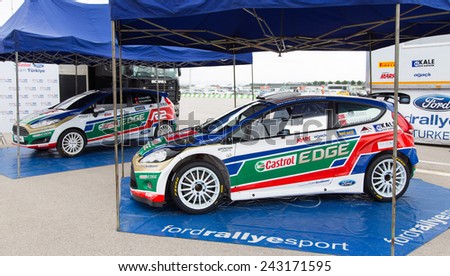 ISTANBUL, TURKEY - OCTOBER 11, 2014: Murat Bostanci with Ford Fiesta S2000 of Castrol Ford Team Turkey in garage area of Istanbul Park circuit during FIA World Rallycross Championship.