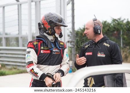 ISTANBUL, TURKEY - OCTOBER 11, 2014: Petter Solberg talk with his mechanic before FIA World Rallycross Championship.