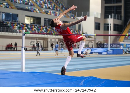 ISTANBUL, TURKEY - JANUARY 17, 2015: Athlete Enes Talha Senses high jump during Ruhi Sarialp clubs jumping championship and athletics record attempt races in Asli Cakir Alptekin Athletics hall
