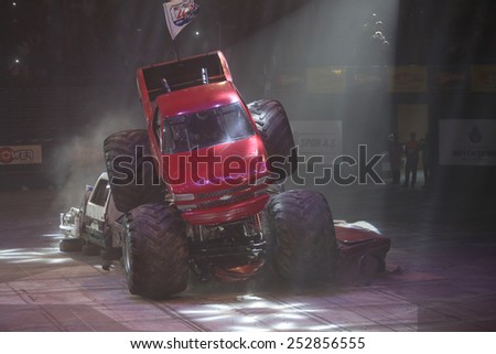 ISTANBUL, TURKEY - FEBRUARY 01, 2015: Monster Truck Lil Devil crush to old cars in Sinan Erdem Dome during Monster Hot Wheels stunt show.