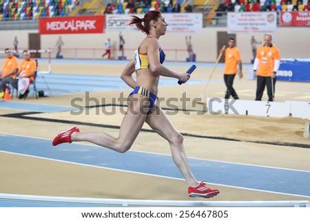 ISTANBUL, TURKEY - FEBRUARY 21, 2015: Rumanian athlete Morosanu Angela running 4x400 relay race during Balkan Athletics Indoor Championships in Asli Cakir Alptekin Athletics hall.