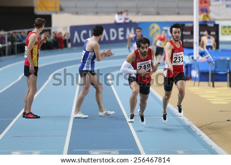 ISTANBUL, TURKEY - FEBRUARY 21, 2015: Athletes running 4x400 relay race during Balkan Athletics Indoor Championships in Asli Cakir Alptekin Athletics hall.