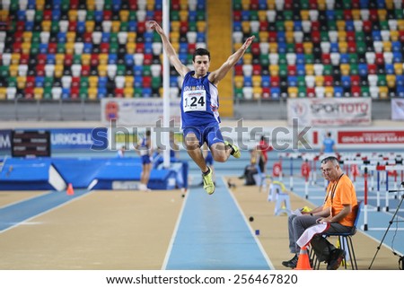 ISTANBUL, TURKEY - FEBRUARY 21, 2015: Armenian athlete Artak Hambardzumyan long jump during Balkan Athletics Indoor Championships in Asli Cakir Alptekin Athletics hall.