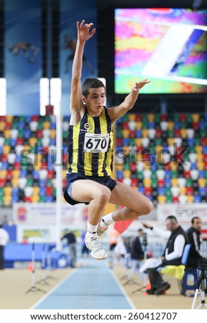 ISTANBUL, TURKEY - FEBRUARY 15, 2015: Athlete Murat Ozbey triple jump during Turkcell Juniors and Seniors Athletics Turkey Indoor Championship in Asli Cakir Alptekin Athletics hall