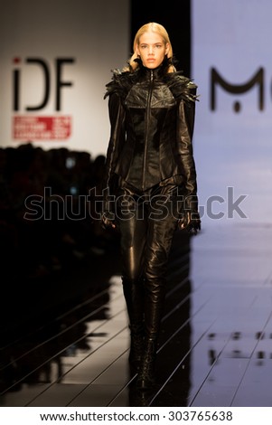 ISTANBUL, TURKEY - NOVEMBER 20, 2014: A model showcases one of the latest creations by Mefi in Istanbul Leather Fair