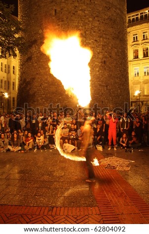 ISTANBUL, TURKEY - SEPTEMBER 18: A street performer blows fire during street shows in Galata square on September 18, 2010 in Istanbul, Turkey
