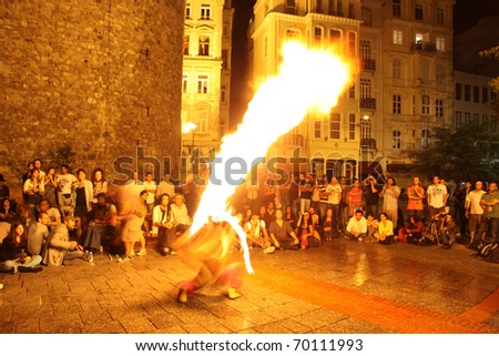 ISTANBUL, TURKEY - SEPTEMBER 05: A street performer blows fire during street shows in Galata square on September 05, 2010 in Istanbul, Turkey