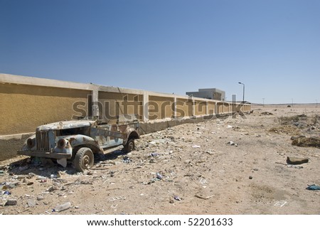stock photo Abandoned old rusty car amidst rubbish El Tor South Sinai