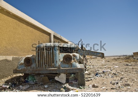 stock photo Abandoned old rusty car amidst rubbish El Tor South Sinai