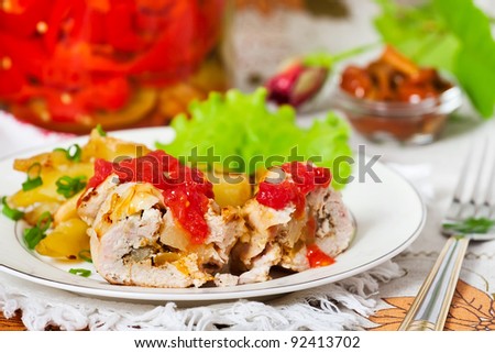 roasted and cut chicken meat stuffed with pineapple pieces with potato on a plate