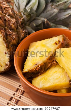 pineapple chunks in a brown bowl