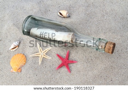 Message in a glass bottle on beach sand