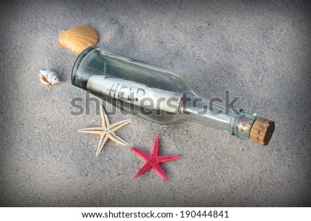 Message in glass bottle on beach sand. Close up image.