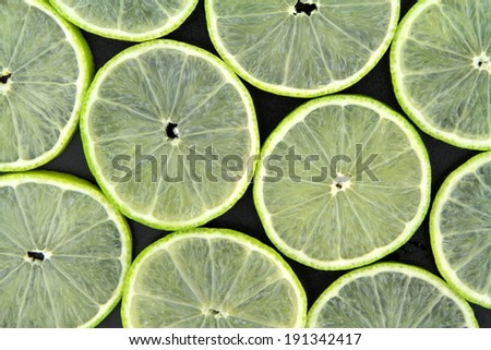 Lime slices on black background