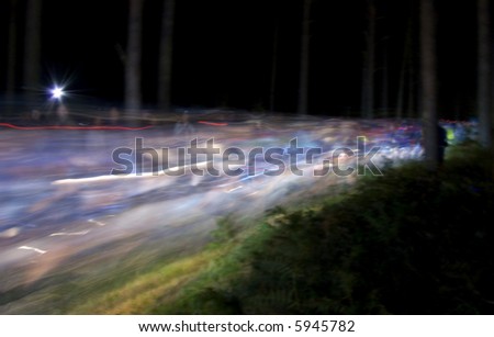 Mountain bike race at the start at night with speeding lights