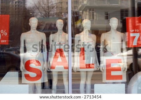 Dummies in a show-window of shop. Sale