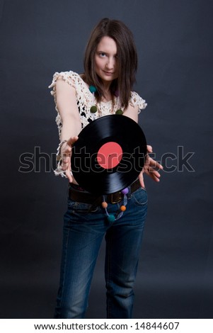 The young woman holds vinyl. Studio shooting