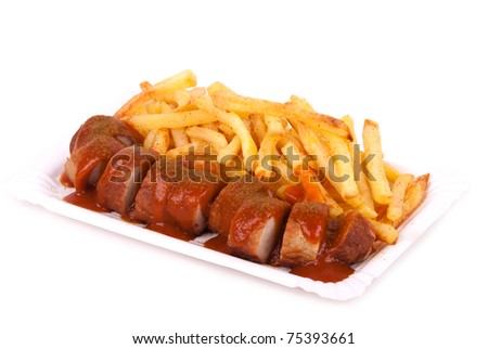 a bowl with curried sausage and chips in front of white background