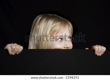 Cute little girl peeking over
