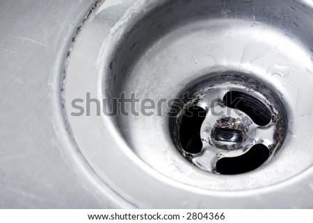 Closeup of a stainless steel sink drain