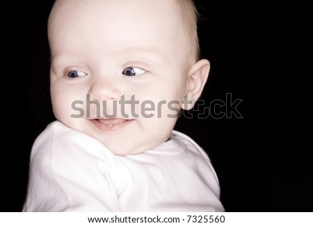 adorable baby with big blue eyes smiling