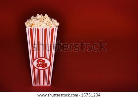 Buttered Popcorn in classic bucket on red background