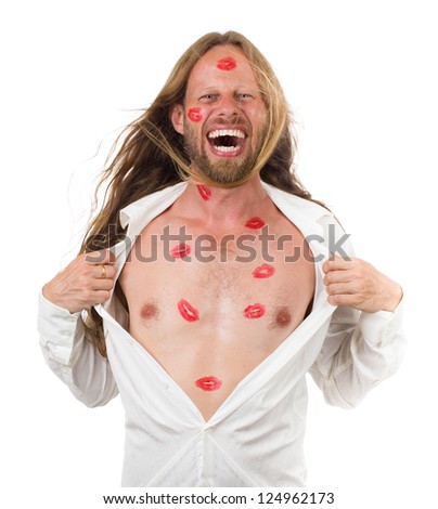 Funny portrait of a very happy man covered in red lipstick kisses yelling and pulling open his white shirt