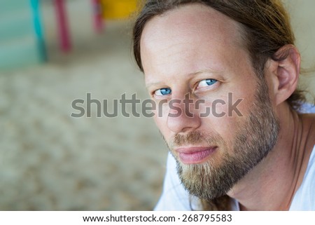 Portrait of a handsome bearded man with blue eyes