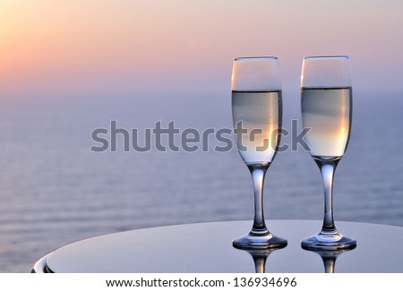 Flutes of champagne with sunset background