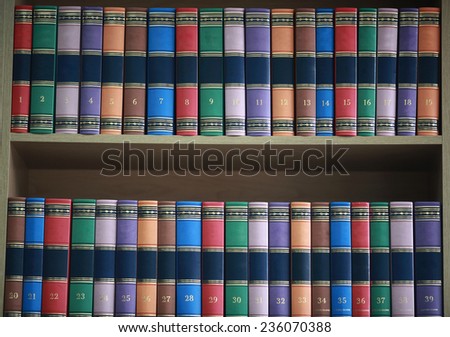 bookshelf with books neatly standing with colored covers
