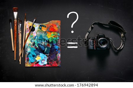 Art paints or digital camera? / studio photography of paint utensils on black background